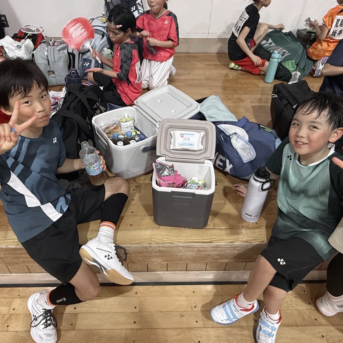 大会会場でクーラーボックスを囲む子どもたち